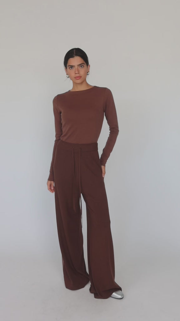 Model wearing brown top and brown pants with truffle stripe.
