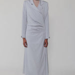 Woman wearing a light blue dress against a white background